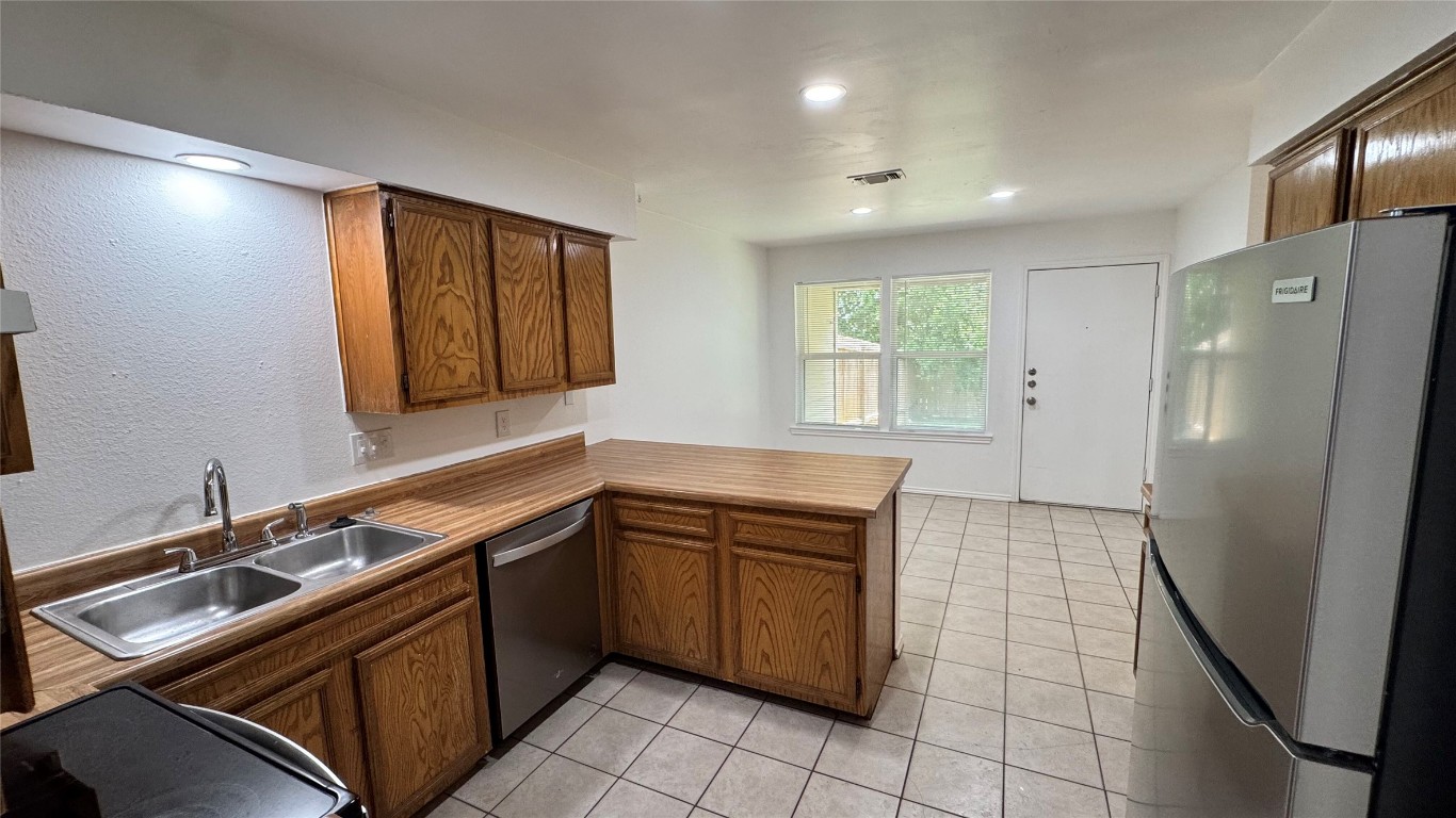1304 Conway Drive, Unit B San Marcos, TX 78666 - Photo 4 of 16 a kitchen with a sink appliances and cabinets