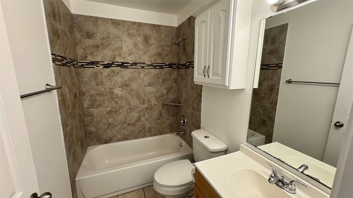 1304 Conway Drive, Unit B San Marcos, TX 78666 - Photo 8 of 16 a white toilet sitting next to a bath tub and a shower