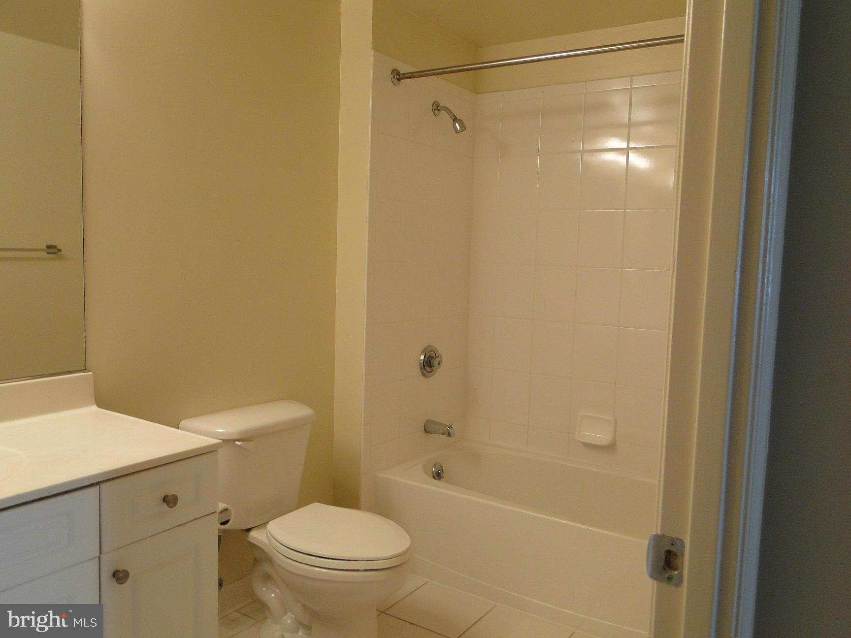 2726 Gallows Road, Unit 611 Vienna, VA 22180 - Photo 14 of 29 a bathroom with a shower a toilet and a sink