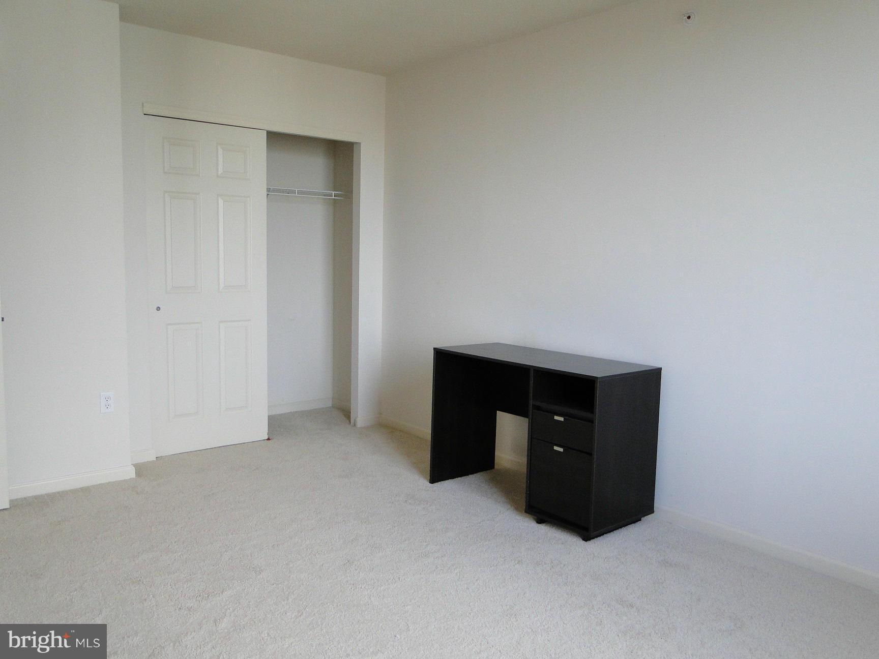 2726 Gallows Road, Unit 611 Vienna, VA 22180 - Photo 16 of 29 a room with a table and two night stand