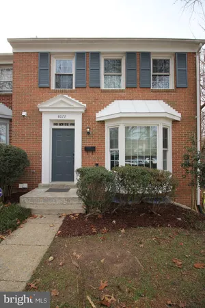 a front view of brick house with a yard