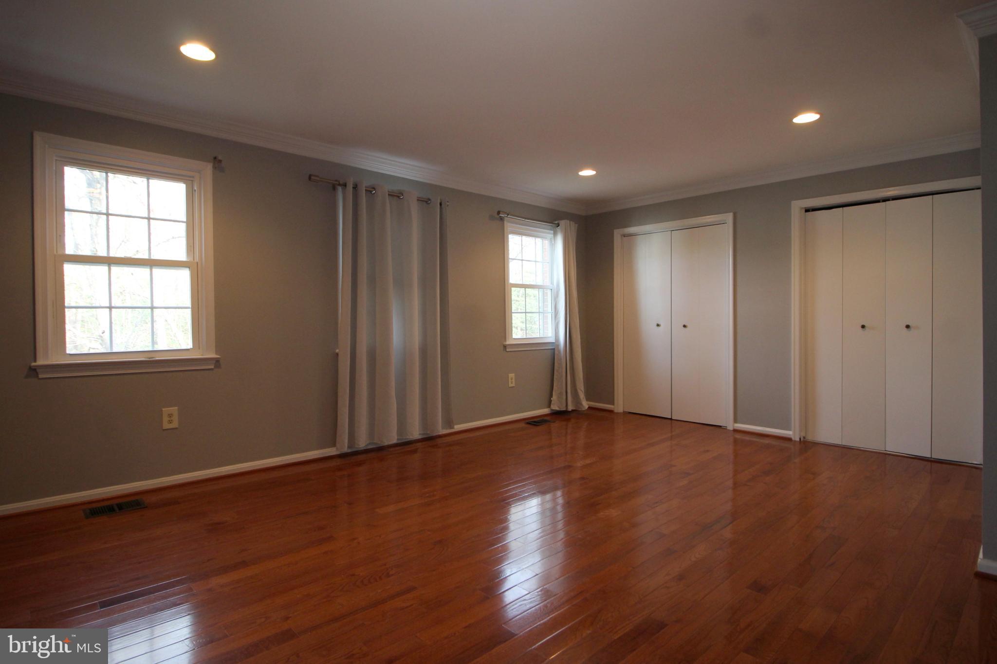 8072 Sleepy View Lane Springfield, VA 22153 - Photo 12 of 30 a view of an empty room with wooden floor and a window