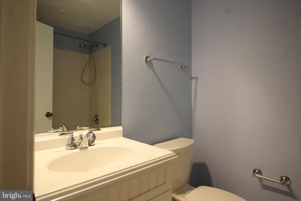 a bathroom with a sink mirror vanity and toilet