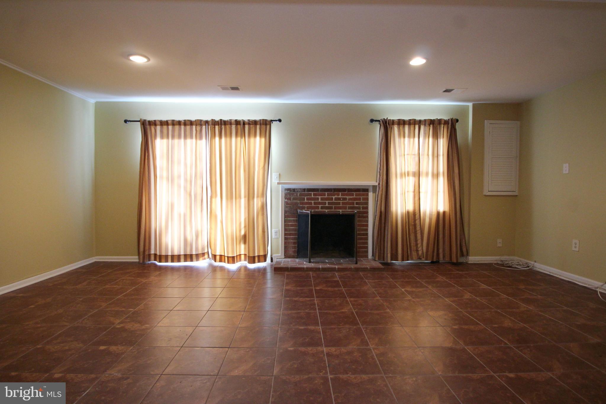 8072 Sleepy View Lane Springfield, VA 22153 - Photo 21 of 30 a view of an empty room with a window and fireplace