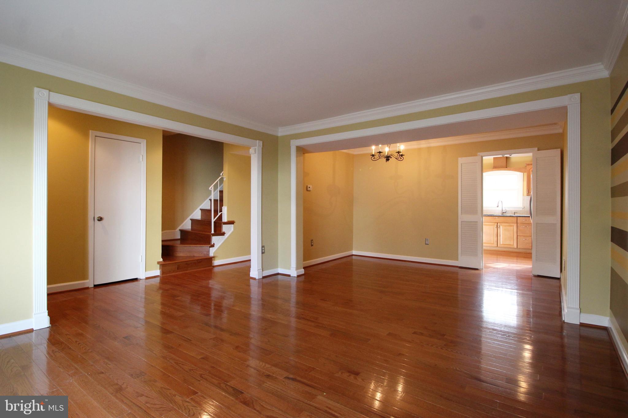 8072 Sleepy View Lane Springfield, VA 22153 - Photo 6 of 30 a view of an empty room with wooden floor and a window