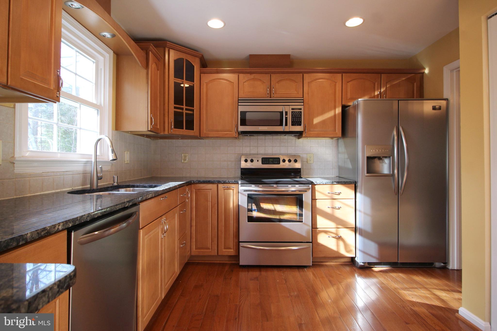 8072 Sleepy View Lane Springfield, VA 22153 - Photo 8 of 30 a kitchen with stainless steel appliances a refrigerator sink and microwave