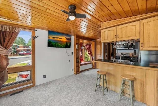 a kitchen with stainless steel appliances granite countertop a stove a refrigerator a oven with white cabinets and wooden floor