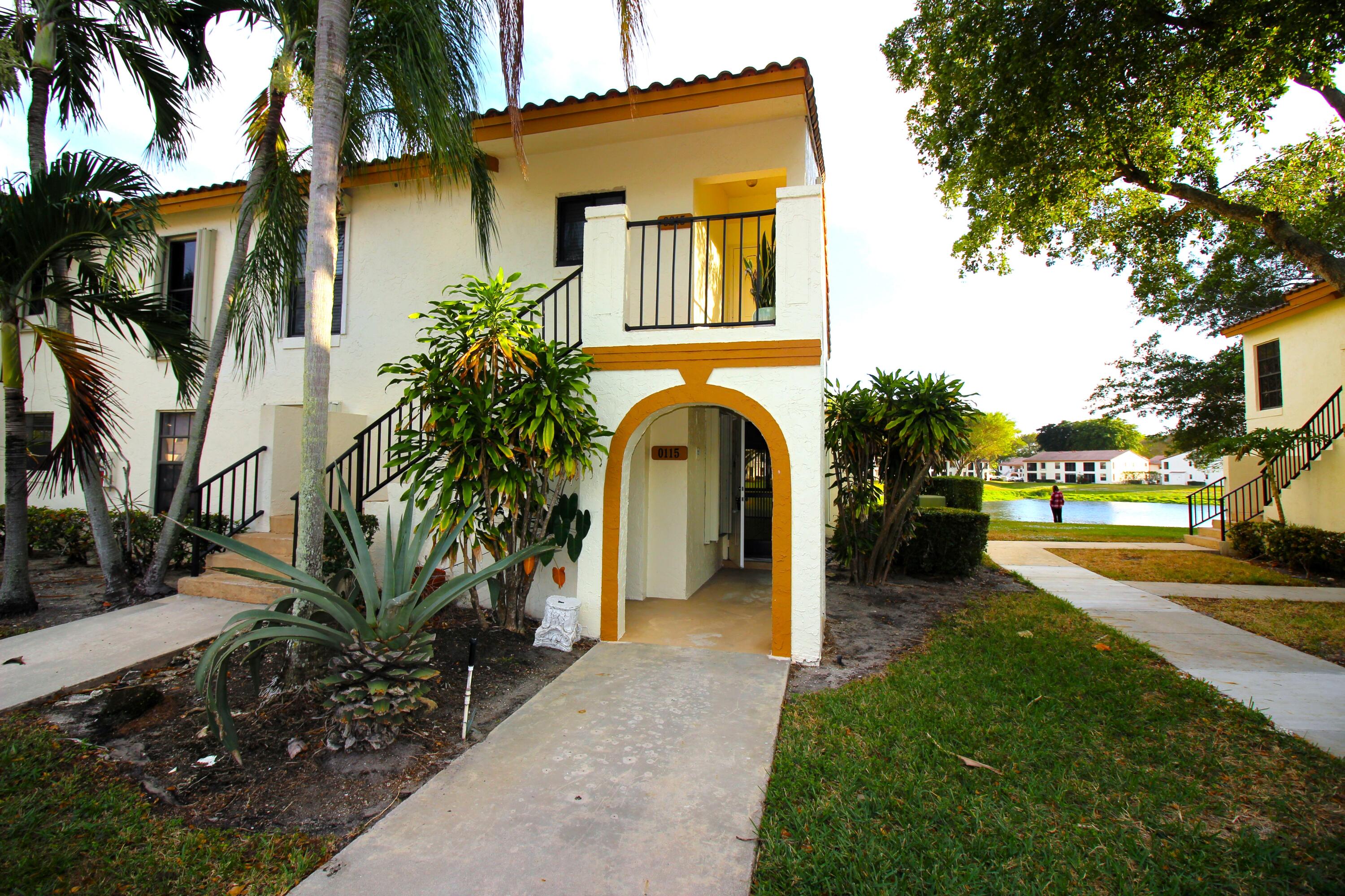 a view of a house with a yard and pathway