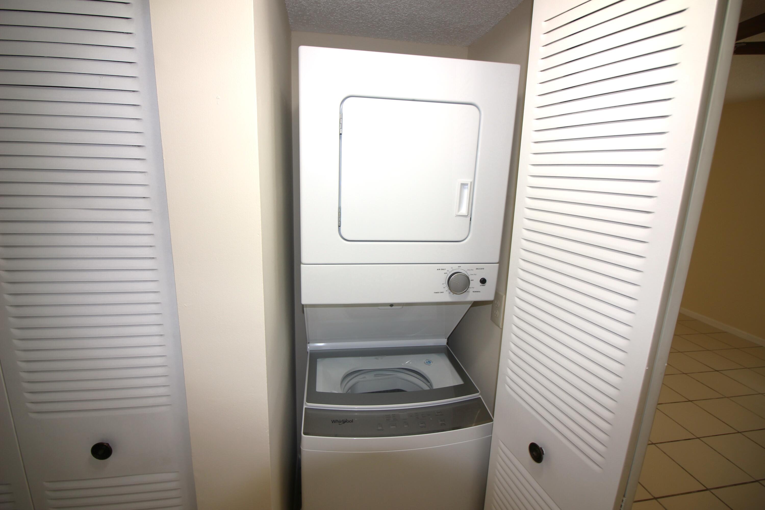 320 Olivewood Place, Unit O115 Boca Raton, FL 33431 - Photo 17 of 56 a utility room with dryer and washer