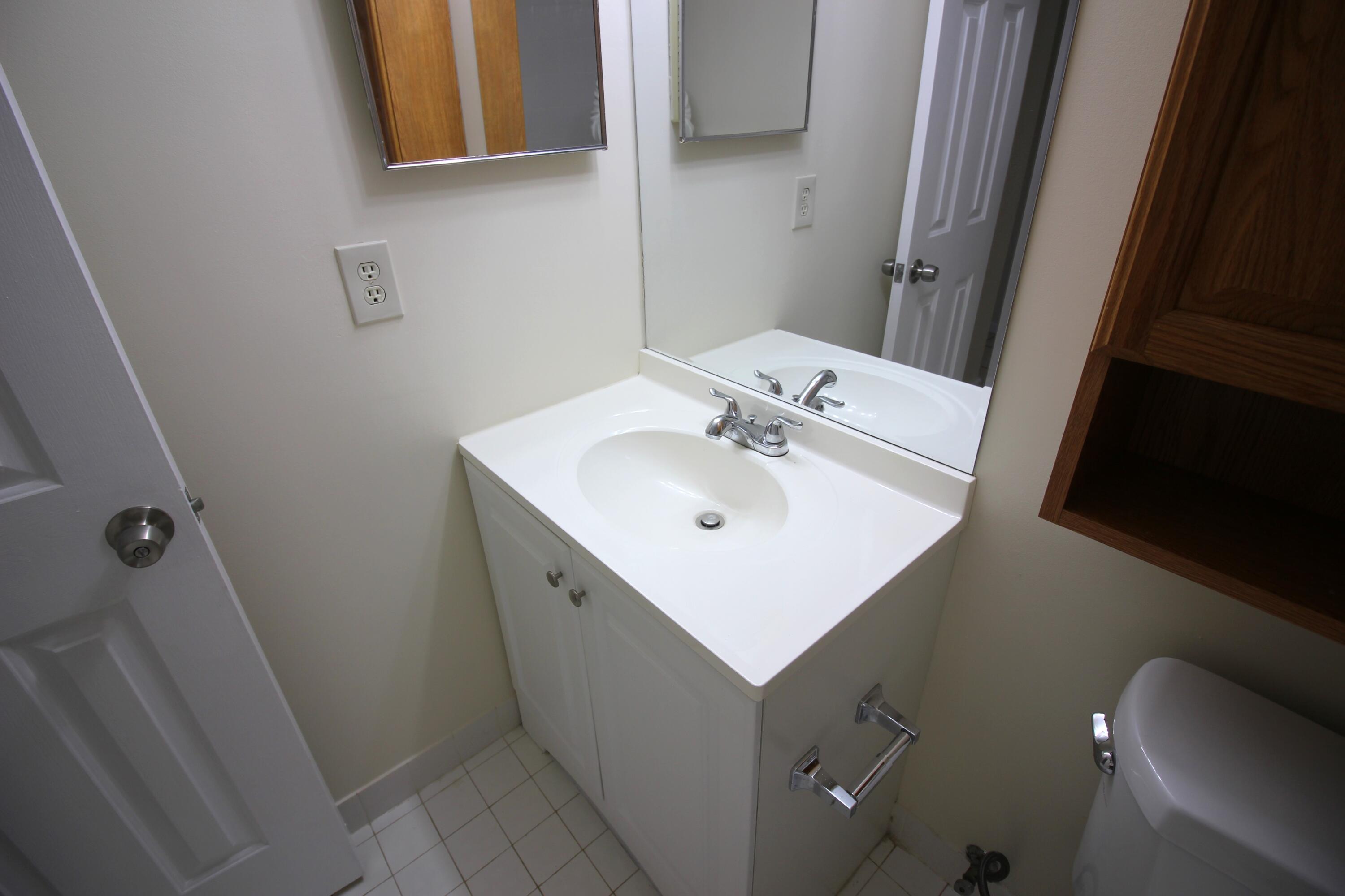 320 Olivewood Place, Unit O115 Boca Raton, FL 33431 - Photo 36 of 56 a bathroom with a sink mirror vanity and toilet