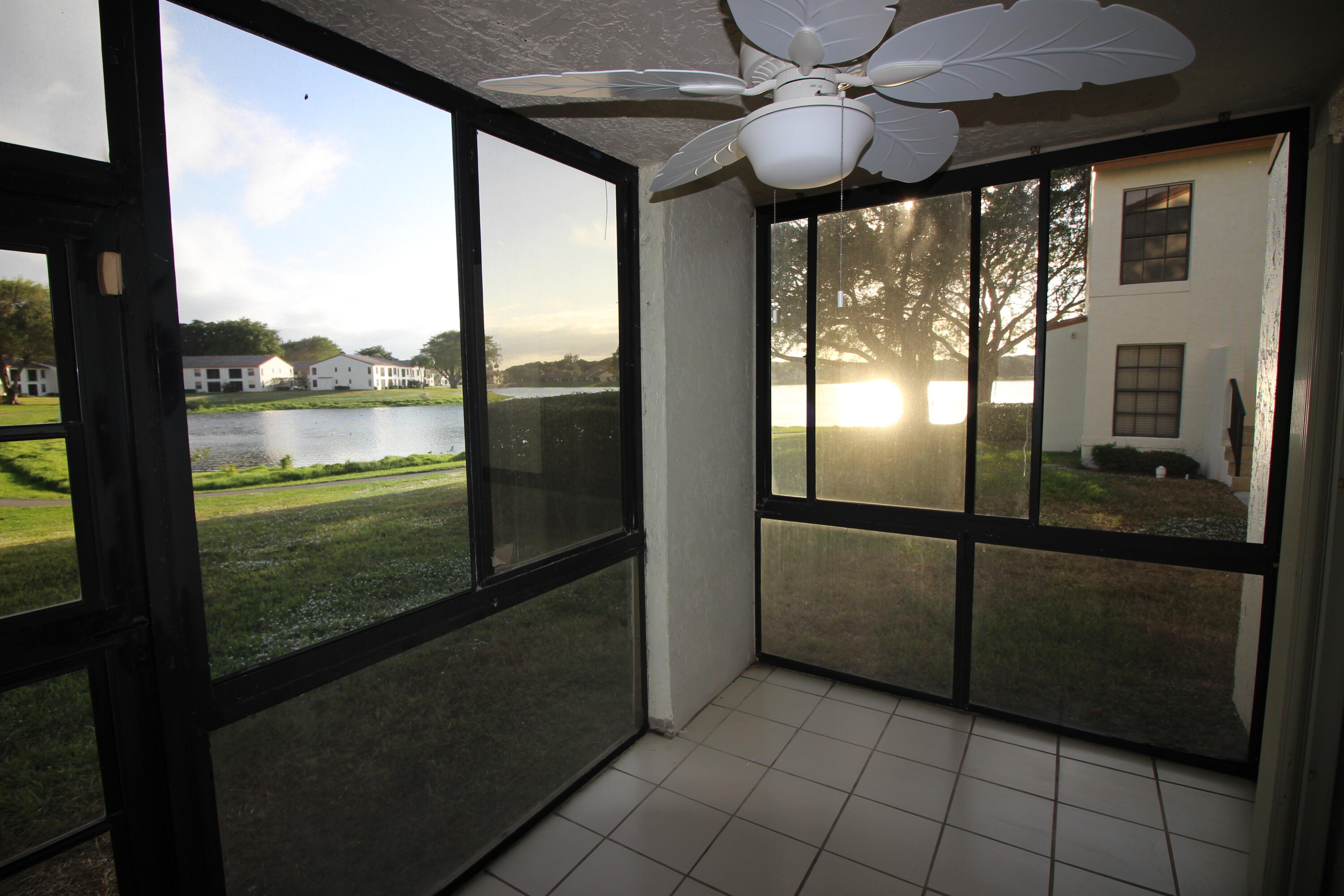 320 Olivewood Place, Unit O115 Boca Raton, FL 33431 - Photo 39 of 56 a view of a livingroom with furniture and floor to ceiling window
