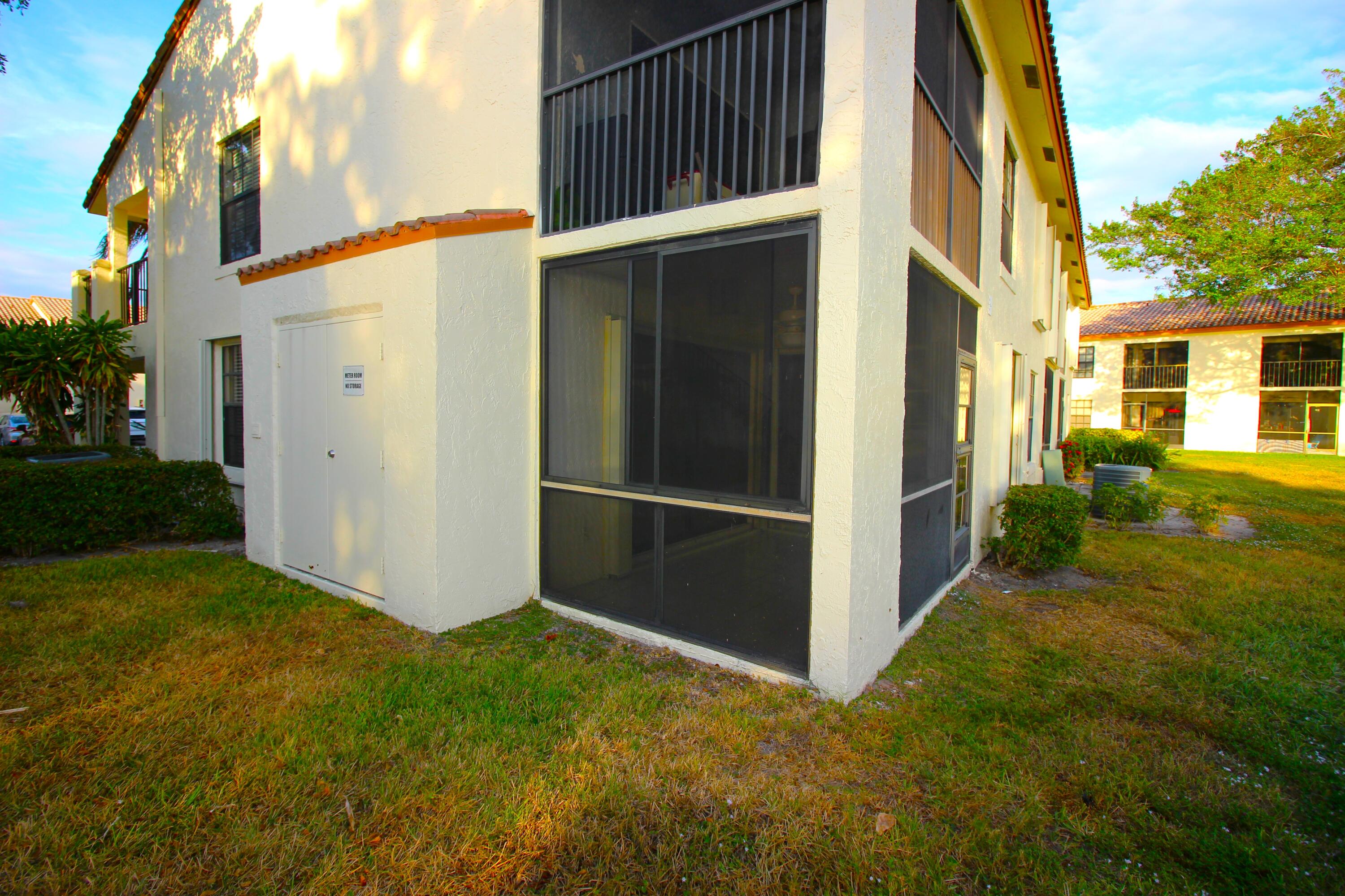 320 Olivewood Place, Unit O115 Boca Raton, FL 33431 - Photo 41 of 56 a view of backyard with barbeque grill and plants