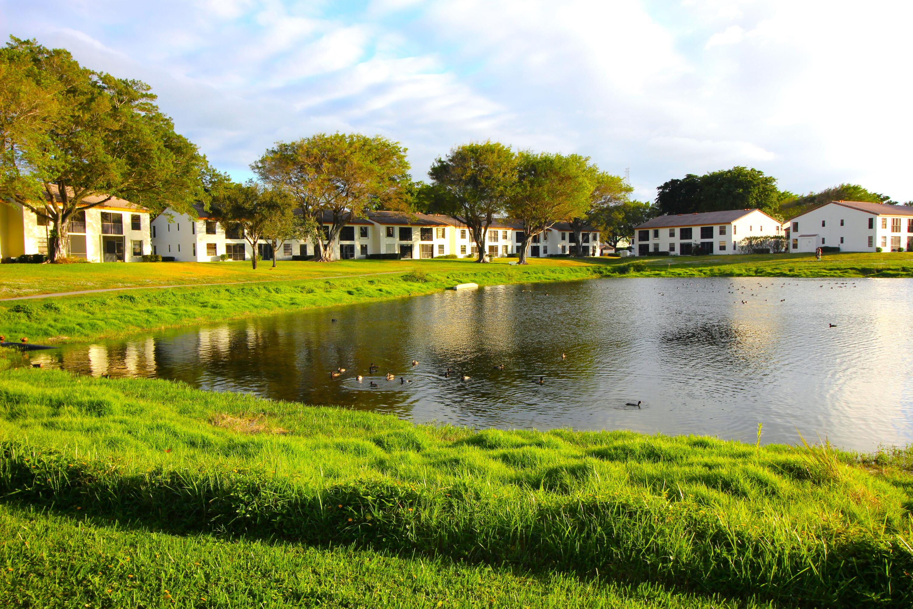 320 Olivewood Place, Unit O115 Boca Raton, FL 33431 - Photo 44 of 56 a view of a lake with houses