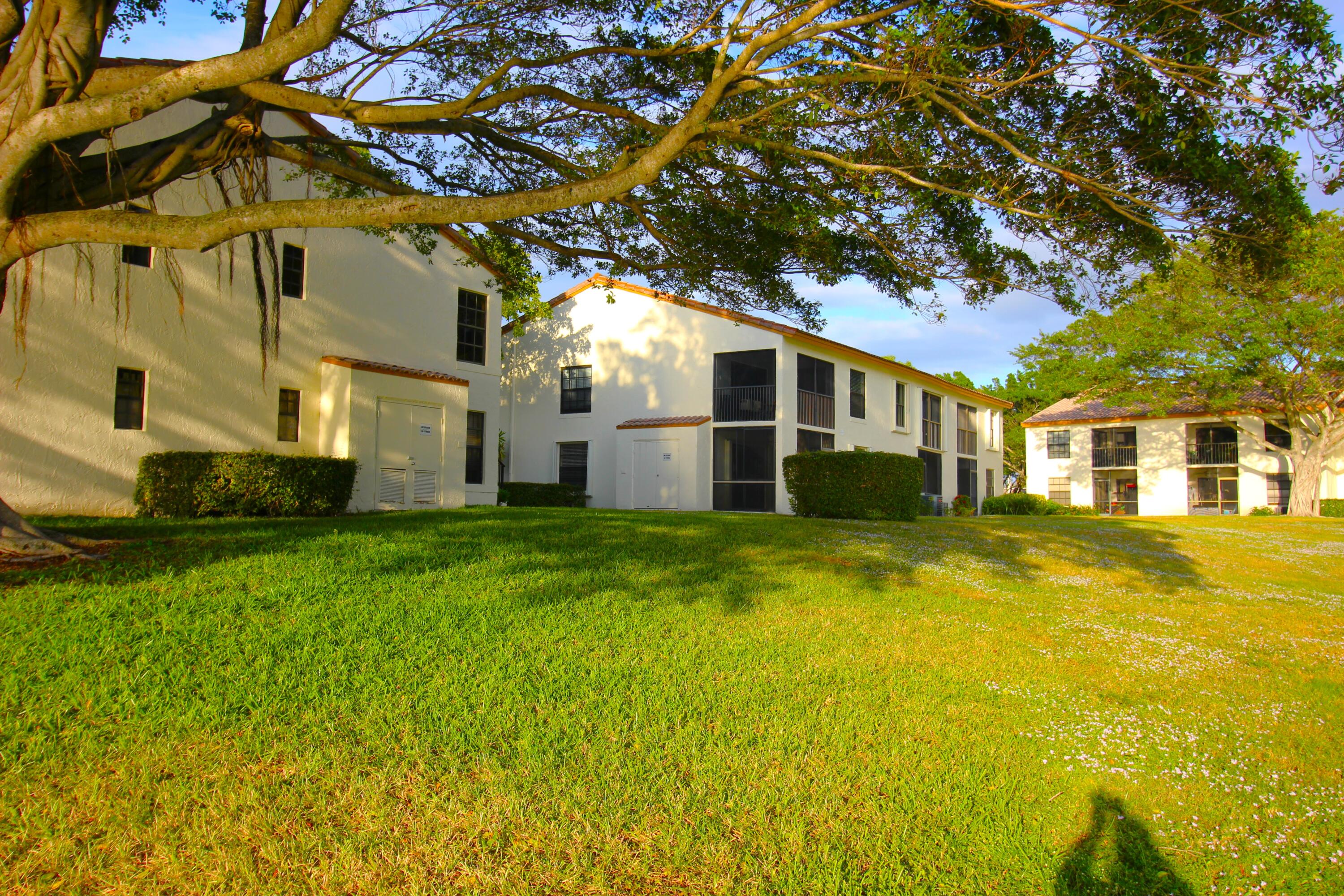 320 Olivewood Place, Unit O115 Boca Raton, FL 33431 - Photo 45 of 56 a front view of a house with a yard
