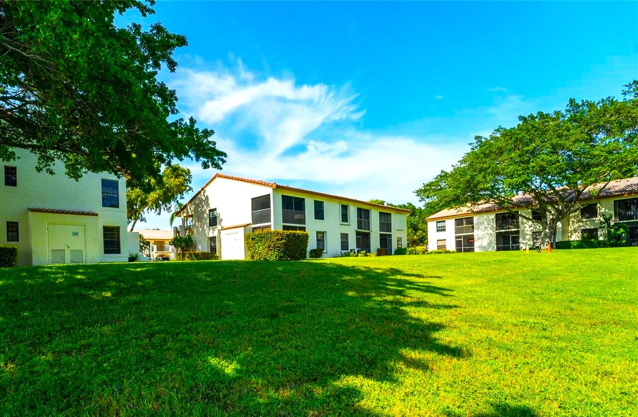 320 Olivewood Place, Unit O115 Boca Raton, FL 33431 - Photo 50 of 56 a front view of a house with a garden