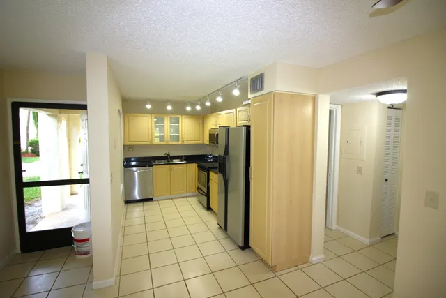 a kitchen with stainless steel appliances a refrigerator and a stove top oven