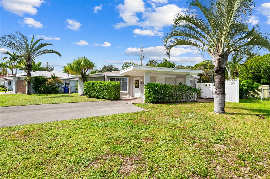 1357 Southwest 4th Terrace Pompano Beach, FL 33060 - Photo 24 of 25 a front view of a house with swimming pool
