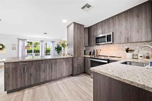 a kitchen with a stove a sink and a microwave
