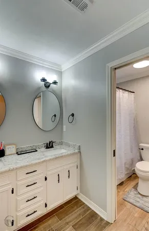 a bathroom with a double vanity sink and a mirror