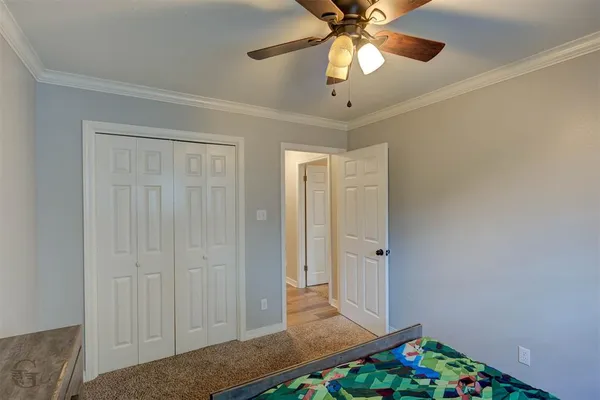 wooden floor in an empty room with a chandelier