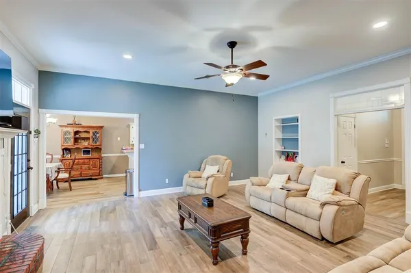 a living room with furniture and wooden floor