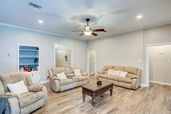 a living room with furniture a ceiling fan and a rug