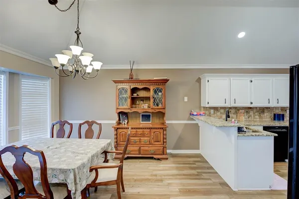 a living room with kitchen island furniture and a chandelier