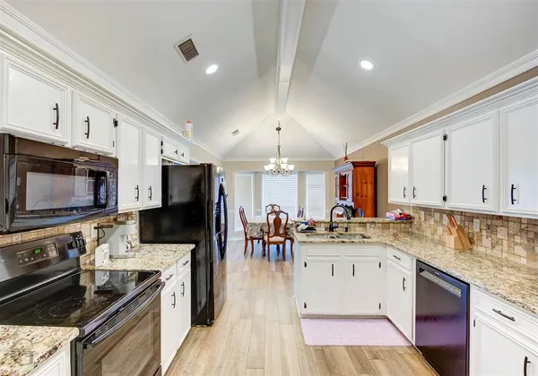 a kitchen with stainless steel appliances a stove sink microwave and cabinets