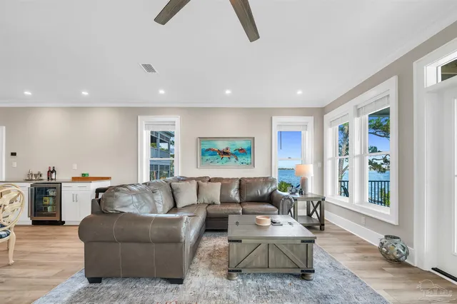 a living room with furniture ceiling fan and a window