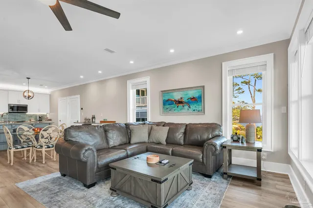a living room with furniture and kitchen view