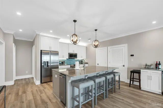 a large kitchen with a table and chairs