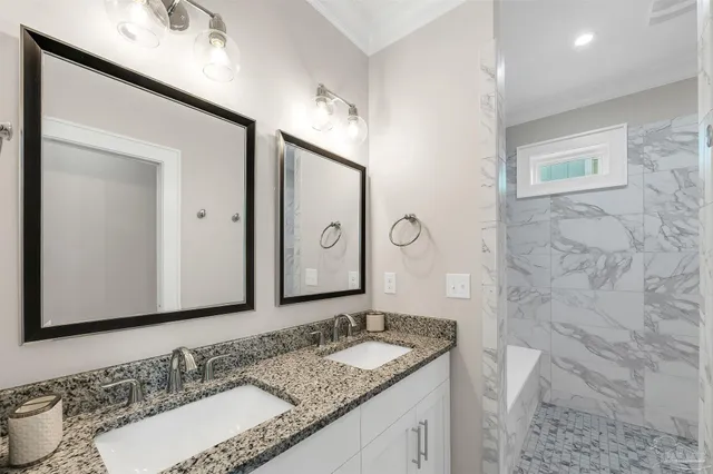 a bathroom with a granite countertop sink mirror and double