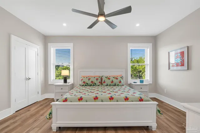 a front view of a house with a yard and trees