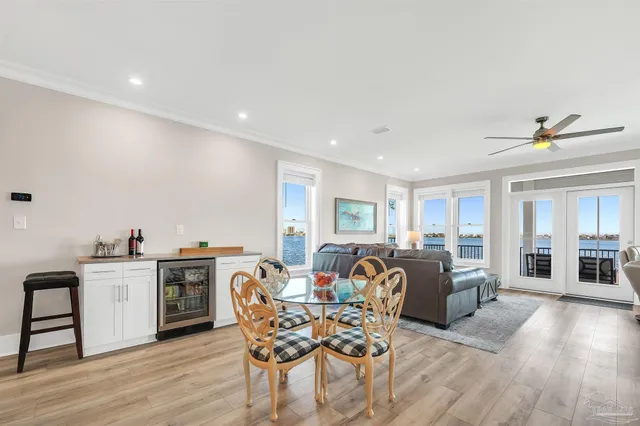 a living room with furniture ceiling fan and a window