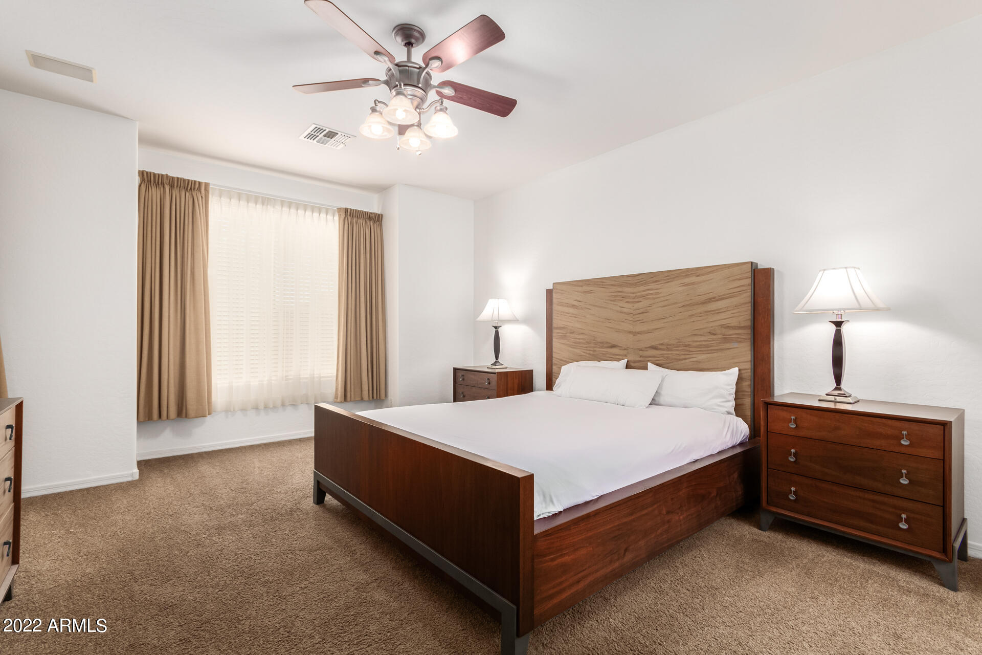 4723 East Timberline Road Gilbert, AZ 85297 - Photo 18 of 30 a bedroom with a bed and a chandelier