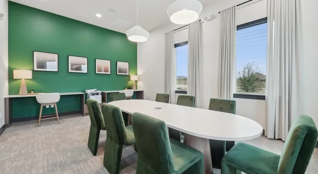a view of a dining room with furniture and a window