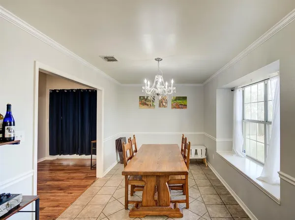 a view of a dining room with furniture and chandelier