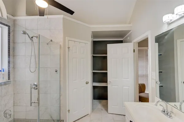 a bathroom with a shower and a sink