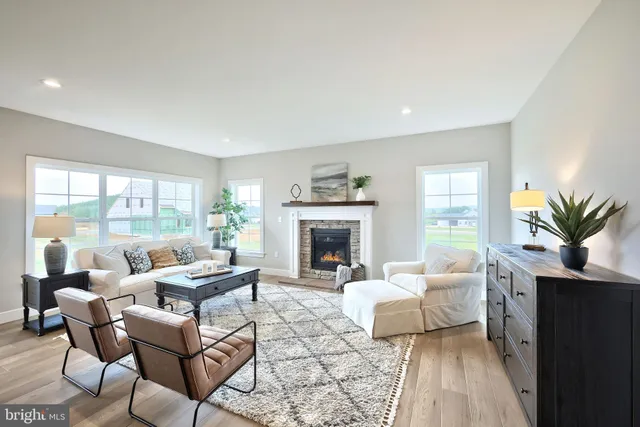 a living room with furniture large window and a fireplace