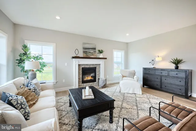 a living room with furniture a fireplace and a window