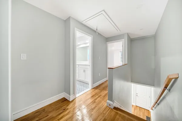 a view of hallway with wooden floor