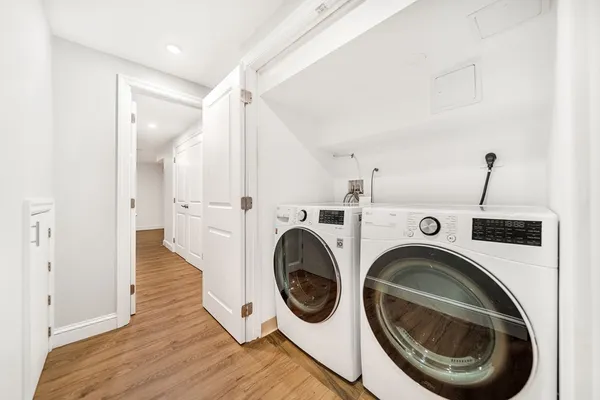 a view of a hallway with washer and dryer