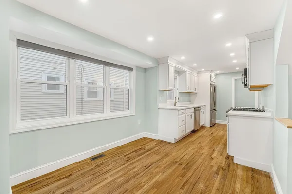 a kitchen with a refrigerator and a stove top oven