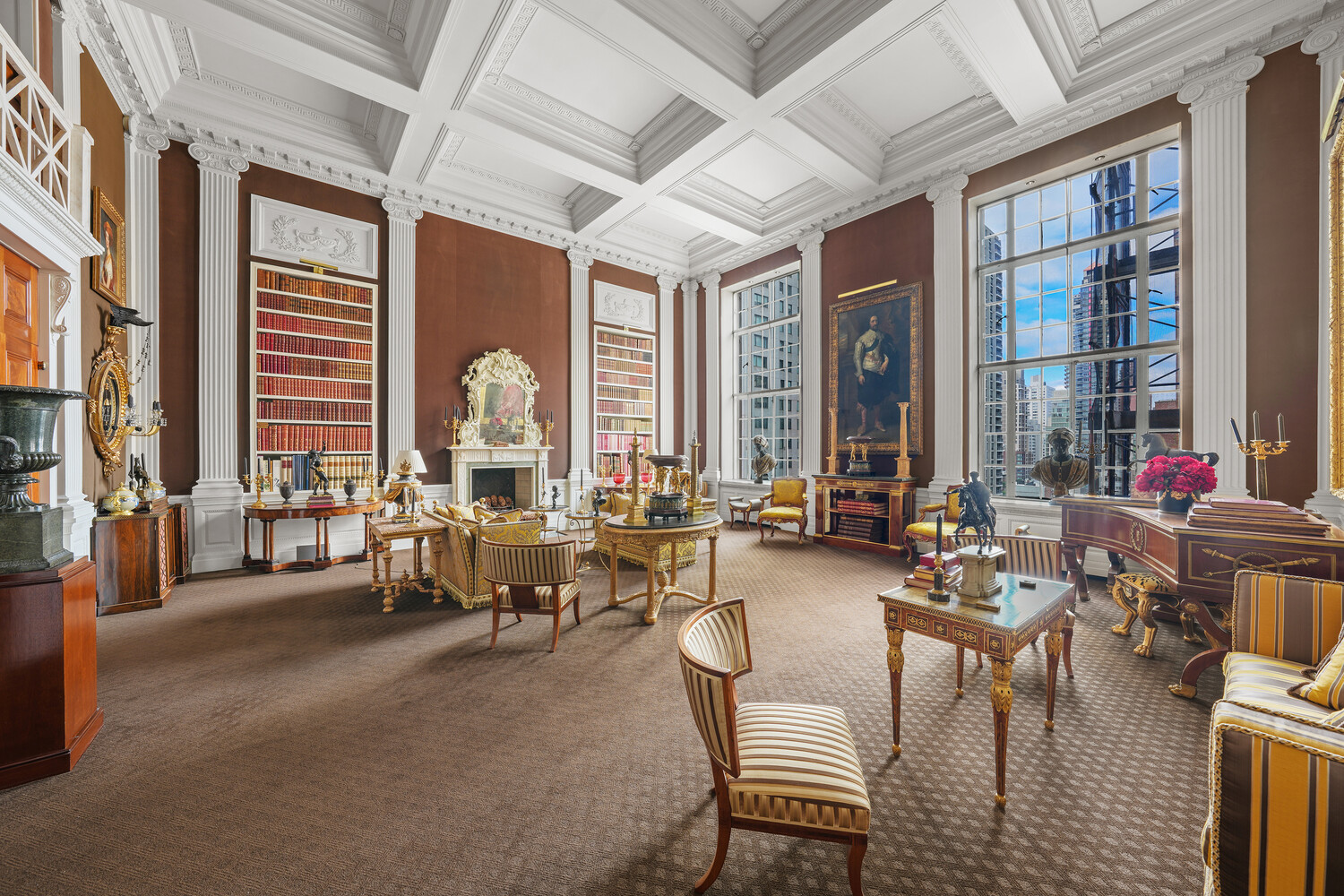a living room with fireplace furniture and a large window