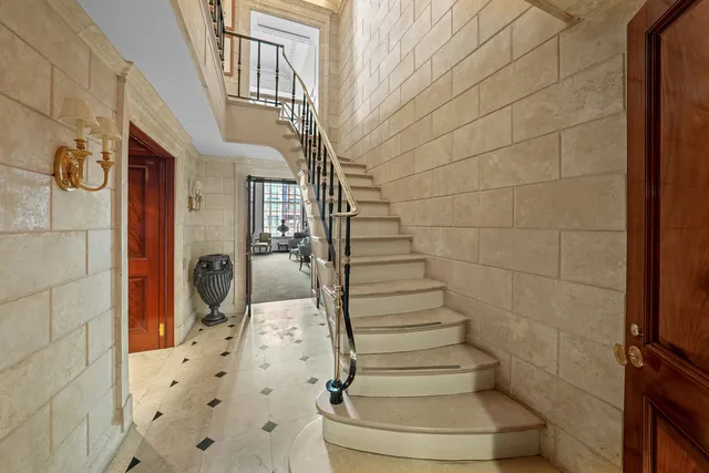 a living room with patio furniture and a large window