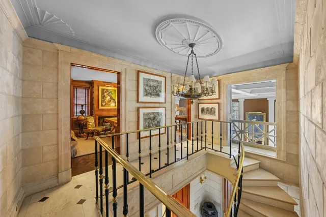 a living room with furniture two window and wooden floor