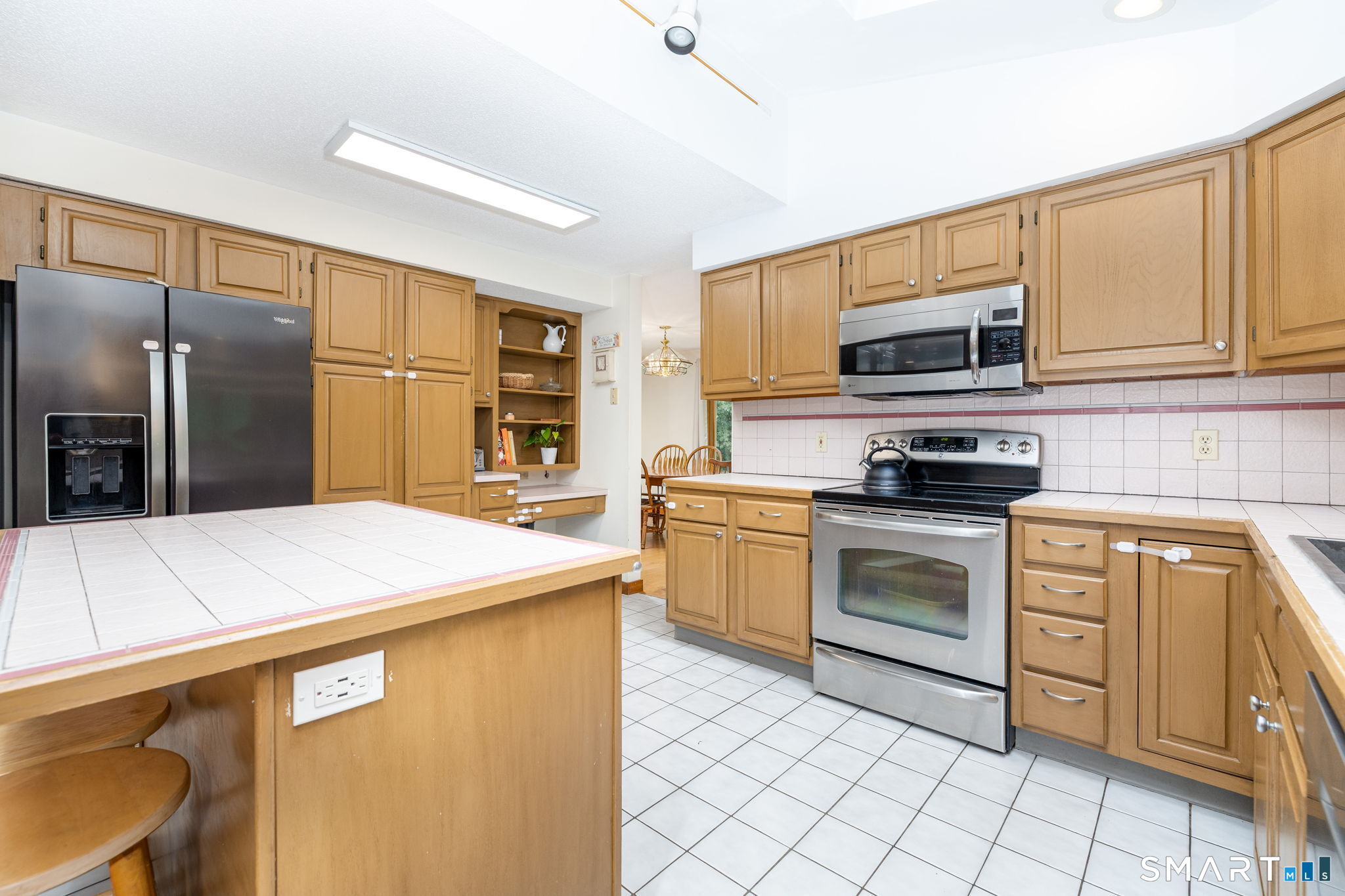 1386 Cedar Swamp Road Coventry, CT 06238 - Photo 15 of 39 Kitchen flows directly into the dining room, featuring a slider that provides easy access to the outdoor entertaining area.