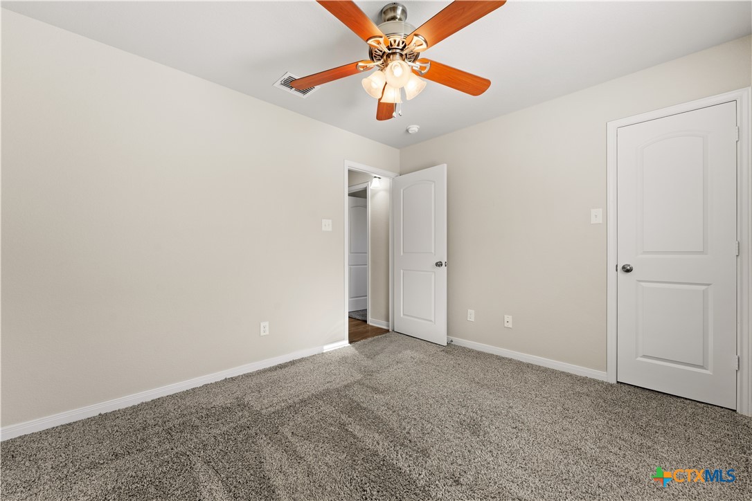 4124 Riata Ranch Road Waco, TX 76705 - Photo 19 of 26 an empty room with closet and fan
