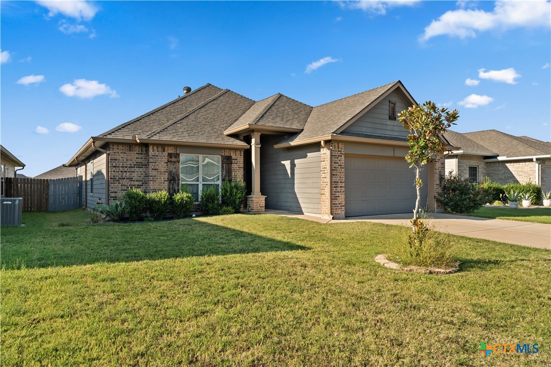 4124 Riata Ranch Road Waco, TX 76705 - Photo 2 of 26 a view of a house with a yard and garage