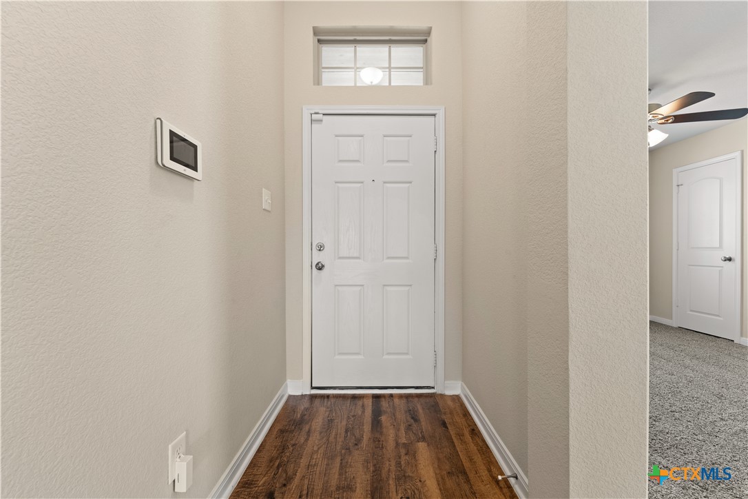 4124 Riata Ranch Road Waco, TX 76705 - Photo 4 of 26 a view of a bedroom from the hallway